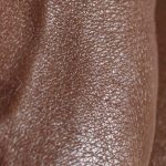 Spot - Closeup of crop unrecognizable ethnic person with veins on hand touching glowing body skin