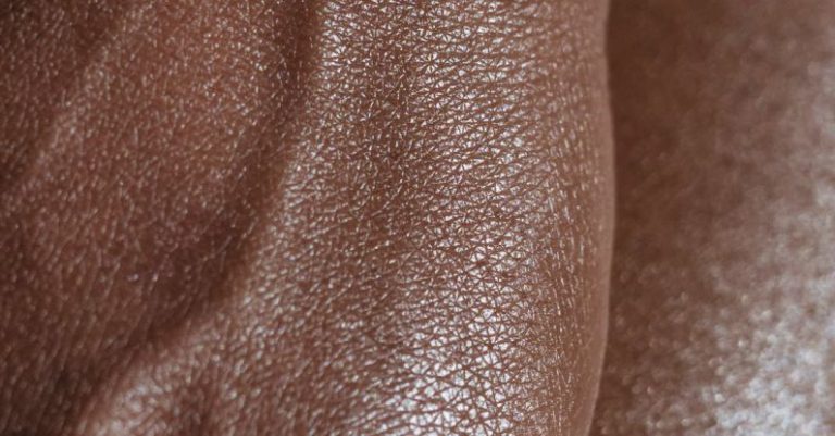 Spot - Closeup of crop unrecognizable ethnic person with veins on hand touching glowing body skin