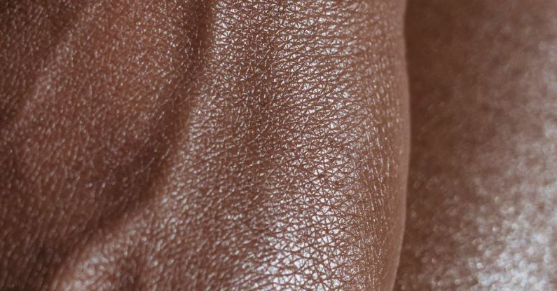 Spot - Closeup of crop unrecognizable ethnic person with veins on hand touching glowing body skin