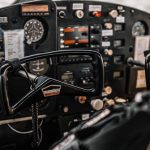Charter - Control panel and yokes of modern light aircraft parked on aerodrome under cloudy sky