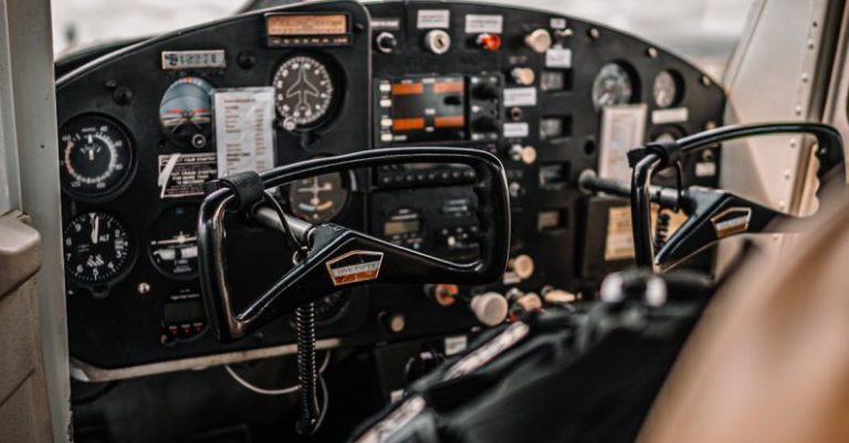 Charter - Control panel and yokes of modern light aircraft parked on aerodrome under cloudy sky