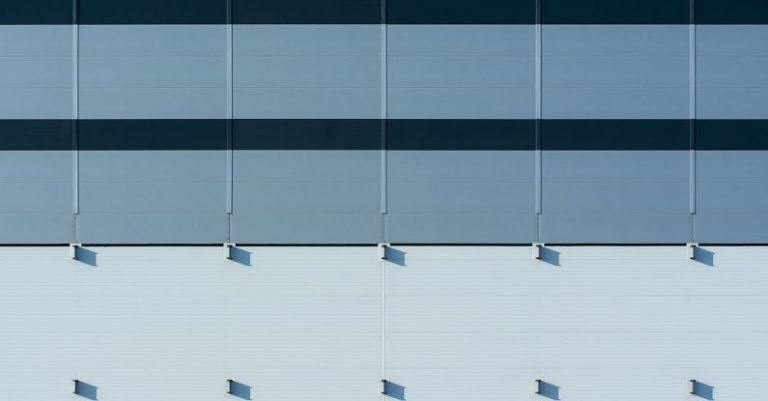 Panels - A close up of a building with blue and white stripes