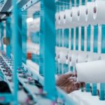 Inspection - Man in Black Jacket Standing Beside Blue Metal Machine