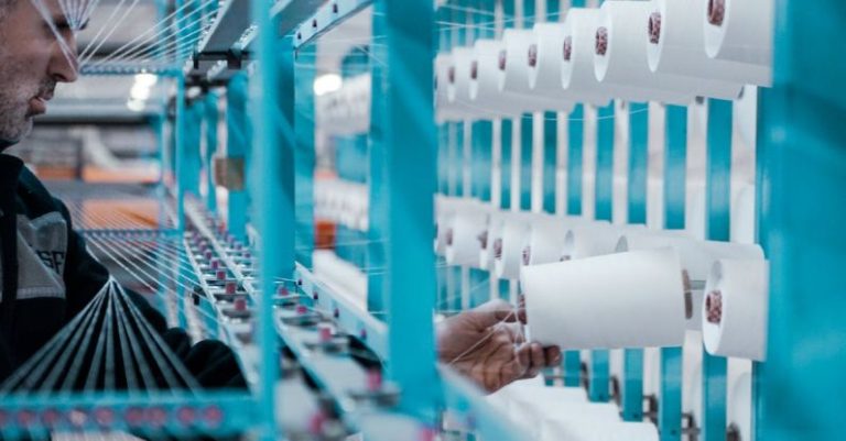 Inspection - Man in Black Jacket Standing Beside Blue Metal Machine