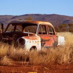 Corrosion - Photo of Corroded Vintage White and Red Sedan on Brown Grass