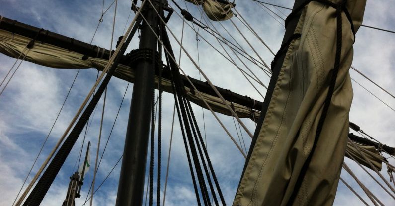 Regattas - Low-angle Photography of Rolled Up Sails on Ship Under Cloudy Sky