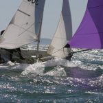 Regatta - Person in Blue and White Sailboat on Body of Water during Daytime