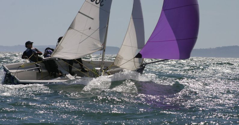 Regatta - Person in Blue and White Sailboat on Body of Water during Daytime